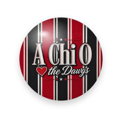 Alpha Chi Omega #056 button. Red, black and cream vertical stripes with cream serif “A Chi O”, a red heart, cream script “the Dawgs” and small stars.