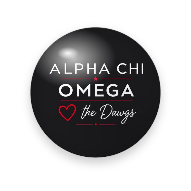 Alpha Chi Omega #057 button. Glossy black background with the full name spelled out in white spaced capitals, a red outlined heart and white script “the Dawgs.”