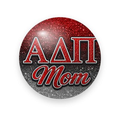 Alpha Delta Pi #053 button. Red-to-silver glitter background with red glitter Greek letters outlined in black and red glitter script “Mom.”