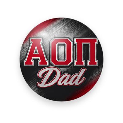 Alpha Omicron Pi #033 button. Black and silver brushed-metal streak behind red varsity Greek letters outlined in silver and silver script “Dad.”