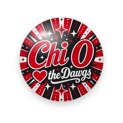 Chi Omega #076 button. Red, black, and white sunburst rays with sparkles behind glossy red “Chi O” script, a red heart, and “the Dawgs” in black script.