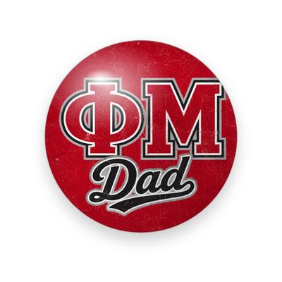 Phi Mu #035 button. Distressed red background with red block Greek letters outlined in black and white above black script “Dad.”