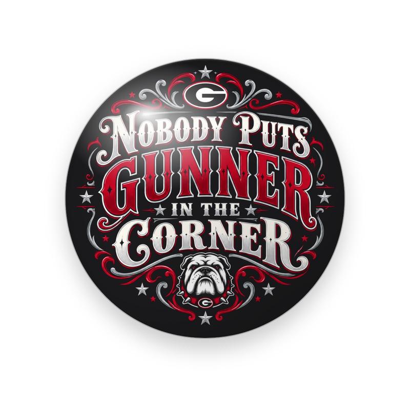 UGA #072 button. Black background with red scrollwork, a small “G” emblem, “Nobody Puts Gunner in the Corner” in silver and red serif capitals, and a bulldog.