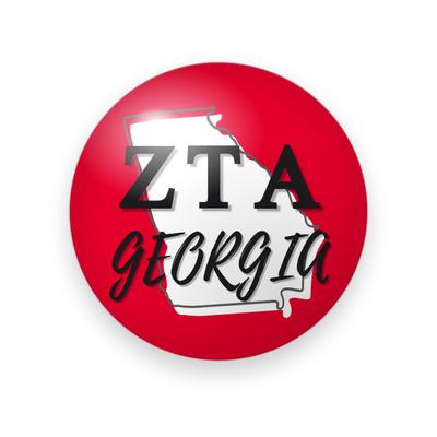 Zeta Tau Alpha #033 button. Red background with a white Georgia state outline behind black serif Greek letters and “Georgia” in black brush script.